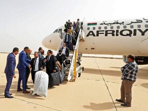 Delegates arrive at the airport of Libya's north-central coastal city of Sirte 