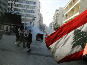 An anti-government demonstrator waves the national flag 