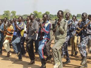 Police trainees, former soldiers of government and rebel groups, attend their training session with handmade wooden rifles or sticks and in civilian clothes at the unified training center in Rejaf on March 25, 2021. Waakhe Simon Wudu / AFP Khartoum, rebel group sign deal separating religion and state