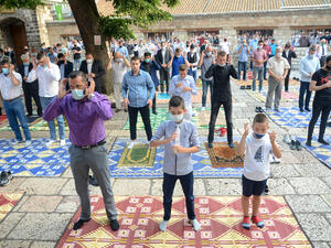 Muslims wearing protective masks whilst praying