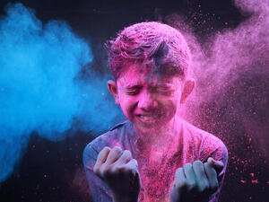 Little boy plays with colors.Concept for Indian festival Holi.