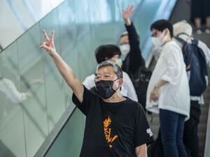 Pro-democracy activist Lee Cheuk-yan (C) gestures outside West Kowloon Court in Hong Kong 