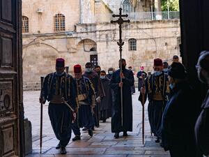 A procession enters the Church of the Holy Sepulchre in Jerusalem