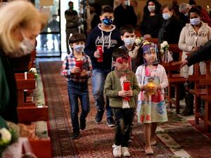 Lebanese Christians, mask-clad due to the coronavirus pandemic