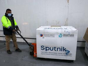 A worker handles the first batch of the Russian Sputnik V vaccine 