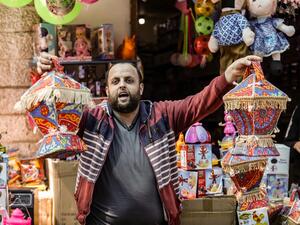 A Palestinian shopkeepers sells lanterns ahead of Ramadan