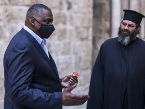 US Defense Secretary Lloyd Austin (L) speaks with a Greek priest and other Christian clergymen outside the Church of the Holy Sepulchre, traditionally believed to be the burial site of Jesus Christ, in Jerusalem's Old City, during his visit to Jerusalem on April 11, 2021. AHMAD GHARABLI / AFP US Secretary of Defense visits Israel to deescalate tension With Iran