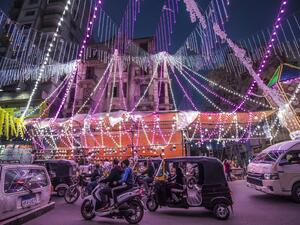 Vehicles, motorcycles, and tuk-tuks (motorised rickshaws) drive past a stall selling Ramadan lanterns along a main street in the in the northern suburb of Shubra (home to a large Christian population) of Egypt's capital Cairo on April 12, 2021, at the start of the Muslim holy fasting month of Ramadan
