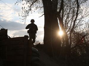 A Ukrainian serviceman patrols near the frontline with Russia backed separatists near Schastya, Lugansk region on April 16, 2021. On the frontline in Ukraine's war-torn east, Ukrainian soldiers keep their weapons ready, as tensions between Kiev and Moscow intensified dramatically since the start of the year.  STR / AFP One Ukrainian soldier killed in Donbas Region.