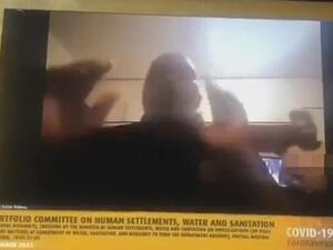 A shocked colleague on the Zoom call an be heard crying out: 'Inkosi, people behind you are not properly dressed. We are seeing everything'