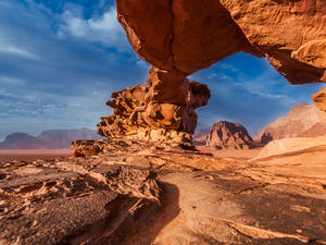 Panoramic view of natural rock bridge and Wadi Rum desert, Jordan