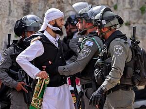 A Palestinian argues with Israeli security forces in Jerusalem's Old City on May 10, 2021, ahead of a planned march to commemorate Israel's takeover of Jerusalem in the 1967 Six-Day War. 