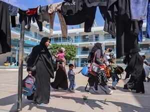Palestinian families take shelter at a United Nations (UN) school in the southern Gaza Strip city of Rafah, on May 17, 2021, as Israeli air strikes hammered the Gaza Strip after a week of violence that has killed more than 200 people, the large majority Palestinian, despite international calls for de-escalation.