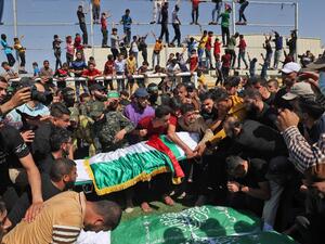 Palestinians carry the bodies of members of the Ezz-Al Din Al-Qassam Brigades, the armed wing of the Hamas movement, who died in Israeli bombardment of a tunnel, during a funeral procession in Khan Younis, in the southern Gaza Strip