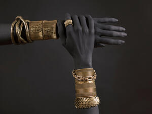 Black woman's hands with gold jewelry