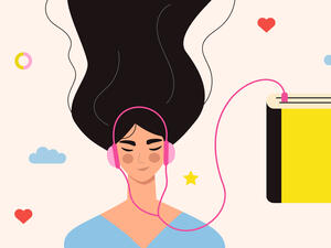 Beautiful young girl in headphones listening to audiobook.