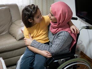 Muslim disabled young woman at home