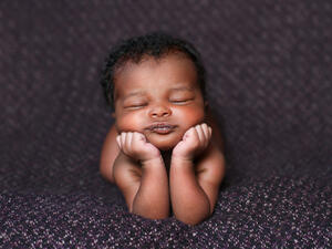 baby resting on her elbows and hands