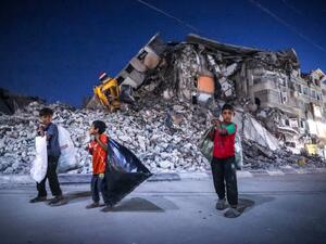 Palestinian boys walk past the destroyed Al-Shuruq tower in Gaza City's al-Rimal neighbourhood which was targeted by Israeli strikes during the recent confrontations between Hamas and Israel