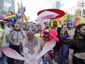Participants march during the Warsaw Gay Pride parade in central Warsaw on June 19, 2021. 