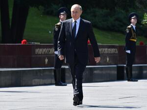 Russian President Vladimir Putin walks to attend the flower-laying ceremony at the Tomb of the Unknown Soldier to mark the 80th anniversary of the German invasion of the Soviet Union in WWII, in Alexander Garden in Moscow 
