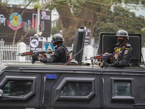 Rapid Action Battalion (RAB) officials stand alert inside a truck in front of Central Shaheed Minar in Dhaka, Bangladesh on February 20, 2021.  © 2021 Sipa via AP Images Rights Groups Call for Decisive Action on International Day for Victims