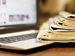 Newspapers and Laptop