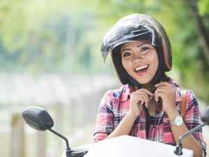  woman wearing a helmet before riding a motorcycle