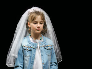 Teen girl trying on a wedding veil