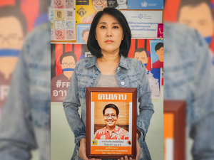 Sitanun Satsaksit holds a portrait of her brother, Wanchalearm, who was forcibly disappeared while living in exile in Cambodia on June 4, 2020.  © 2021 Mirror Foundation  “After one year, the Cambodian and Thai governments’ failure to locate Wanchalearm is glaring,” said Brad Adams, Asia director at Human Rights Watch.