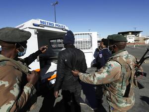 A man suspected of looting is arrested at a shopping mall in Soweto, near Johannesburg, Tuesday July 13, 2021. © 2021 Themba Hadebe/AP Photo Security Forces Should Observe International Law Enforcement Standards