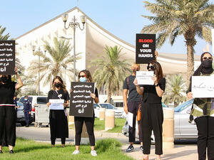 Kuwaiti women raise banners during a rally in Kuwait City. AFP