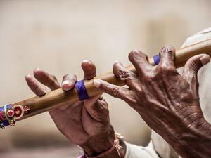 Hands of a man playing a flute