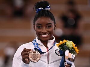 USA's Simone Biles poses with her bronze medal during the podium ceremony of the artistic gymnastics women's balance beam of the Tokyo 2020 Olympic Games at Ariake Gymnastics Centre in Tokyo on August 3, 2021. (Photo: AFP)