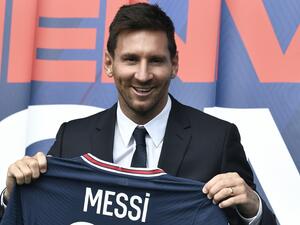Argentinian football player Lionel Messi poses as he holds-up his number 30 shirt during a press conference at the French football club Paris Saint-Germain's (PSG) Parc des Princes stadium in Paris on August 11, 2021. (Photo: AFP)