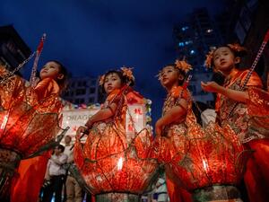 Young girls with lotus lanterns take part in the annual Tai Hang "fire dragon" event, one of the highlights of the city's mid-autumn festival, in Hong Kong  