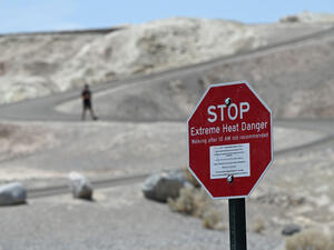 DEATH VALLEY NATIONAL PARK, CALIFORNIA - JULY 11: A warning sign alerts visitors of heat dangers at Zabriskie Point on July 11, 2021 in Death Valley National Park, California..David Becker/Getty Images/AFP / Getty Images via AFP / GETTY IMAGES NORTH AMERICA / David Becker Abandon Deterrence Model for Immigrants, Asylum Seekers, Groups Urge
