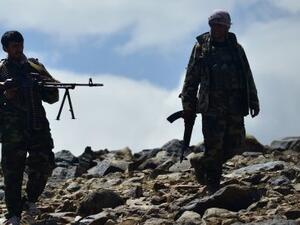  Taliban members standing in front of the gate of the Panjshir provincial governor’s compound
