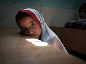 Afghan schoolchildren attend a primary school class
