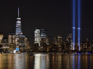 The 9/11 Tribute in Lights temporary monument in lower Manhattan dominates the city skyline.