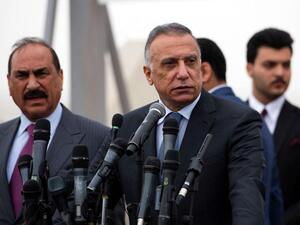 Iraqi Prime Minister Mustafa al-Kadhimi (R) 