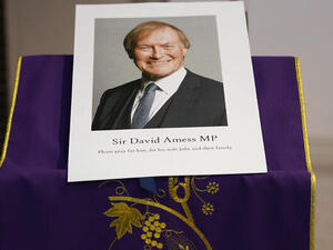 An image of murdered British Conservative lawmaker David Amess is displayed near the altar in St Peters Catholic Church before a vigil in Leigh-on-Sea, Essex, England, Friday, Oct. 15, 2021. (AP/Alberto Pezzali)