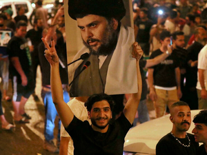 Supporters of Iraqi Shiite cleric Moqtada Sadr celebrate in Baghdad