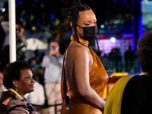 The Fenty Beauty founder chose to go braless as she rocked an orange silk dress and strappy heels. 