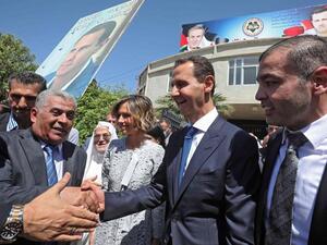 Syrian President Bashar al-Assad greets supporters 