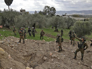 Palestinians residents confront Israeli soldiers in Burqa
