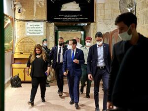 Israeli President Isaac Herzog (C) after storming the Ibrahimi Mosque in Hebron
