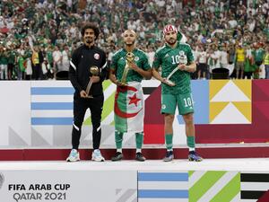 (L to R) Qatar's Akram Afif, Algeria's forward Yacine Brahimi and Algeria's forward Youcef Belaili celebrate with their bronze, golden and silver ball awards respectively during the FIFA Arab Cup 2021 final football match between Tunisia and Algeria at the Al-Bayt stadium in the Qatari city of Al-Khor on December 18, 2021. (Photo by JACK GUEZ / AFP)