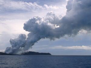 This view taken on January 17, 2015 from a boat at sea shows steam and gas rising from the eruption of a volcano, some 65 kilometres (40 miles) northwest of the South Pacific nation Tonga's capital Nuku'alofa. The Tongan volcano has created a substantial new island since it began erupting in December, spewing out huge volumes of rock and dense ash that has killed nearby vegetation, officials said on January 16. The Lands and Natural Resources Ministry said the volcano was erupting from two vents, one on the uninhabited island of Hunga Ha'apai and the other underwater about 100 metres offshore. AFP PHOTO / Matangi Tonga / Mary Lyn Fonua (Photo by Mary Lyn Fonua / Matangi Tonga / AFP) Tonga Cut Off by Volcanic Blast, Fears Grow for Coastal Towns (AFP)