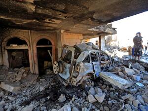 Yemenis inspect the damage following overnight air strikes by the Saudi-led coalition